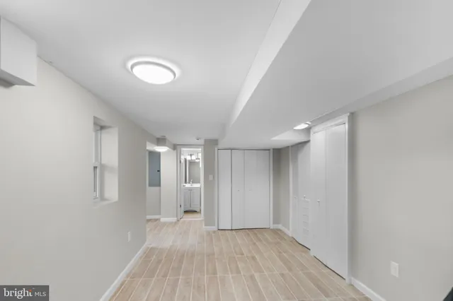 a view of empty room with wooden floor