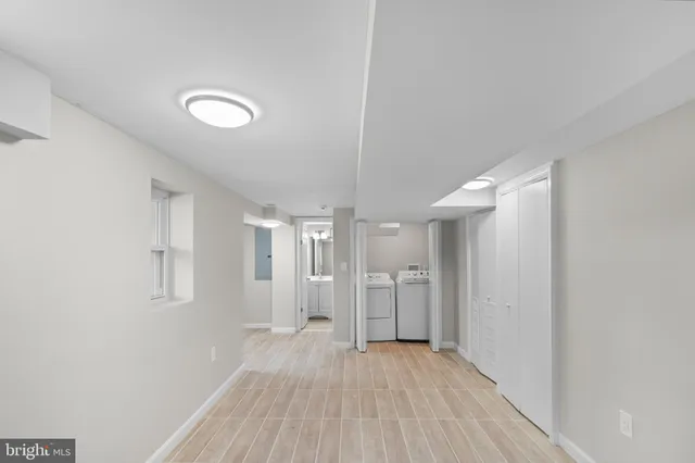 a view of a room with wooden floor and windows
