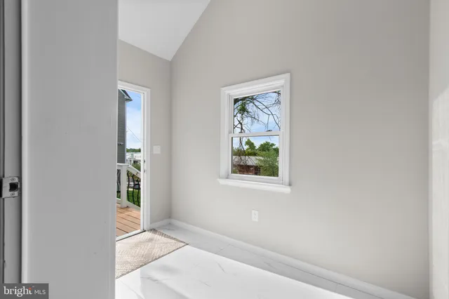 an empty room with windows and closet