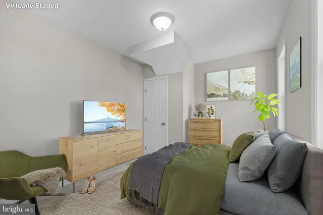 a bedroom with furniture and a flat screen tv