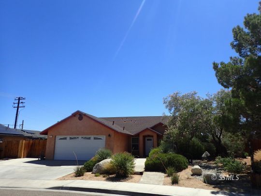 607 Plumblossom Court Ridgecrest, CA 93555 - Photo 2 of 28 a front view of a house with a yard