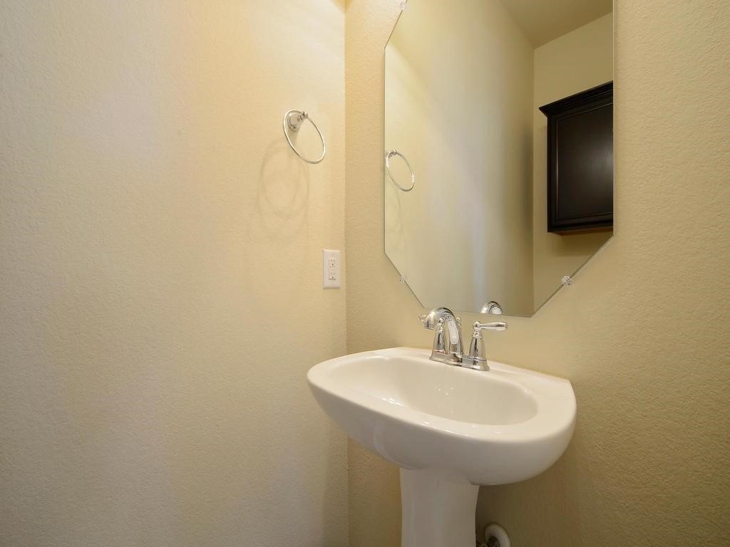 8508 Inca Dove Drive Austin, TX 78729 - Photo 13 of 22 a bathroom with a sink and mirror