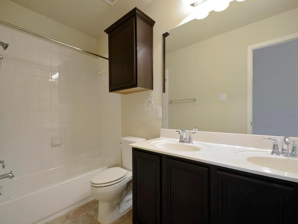 8508 Inca Dove Drive Austin, TX 78729 - Photo 15 of 22 a bathroom with a sink and a toilet