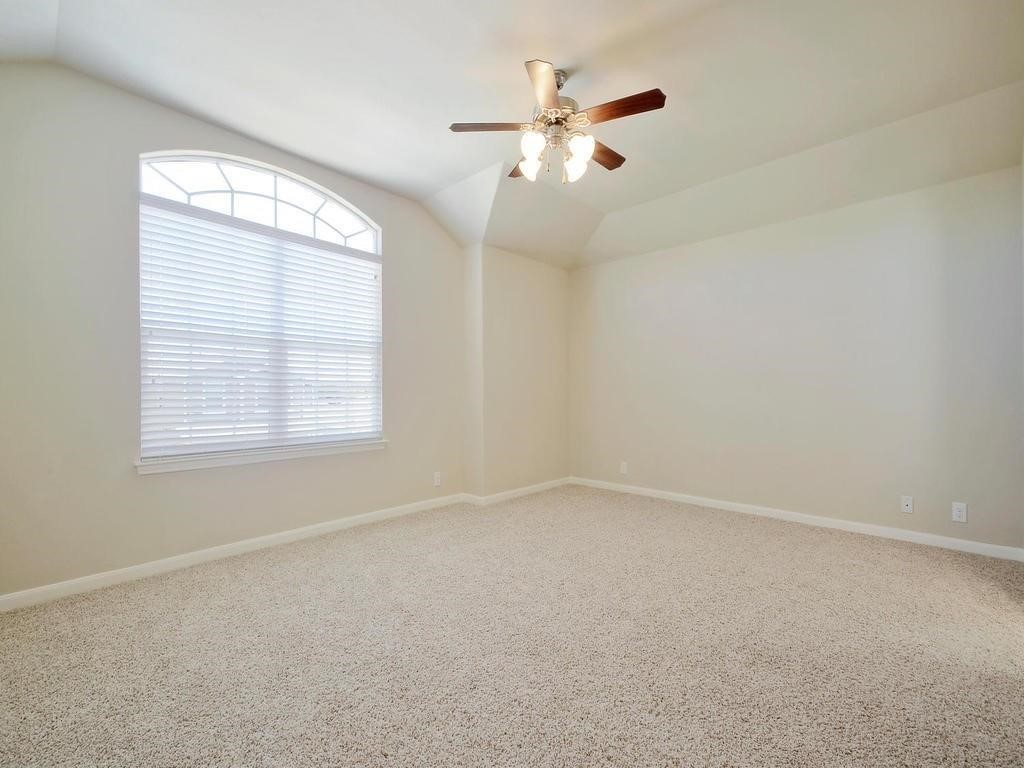 8508 Inca Dove Drive Austin, TX 78729 - Photo 8 of 22 an empty room with windows and fan