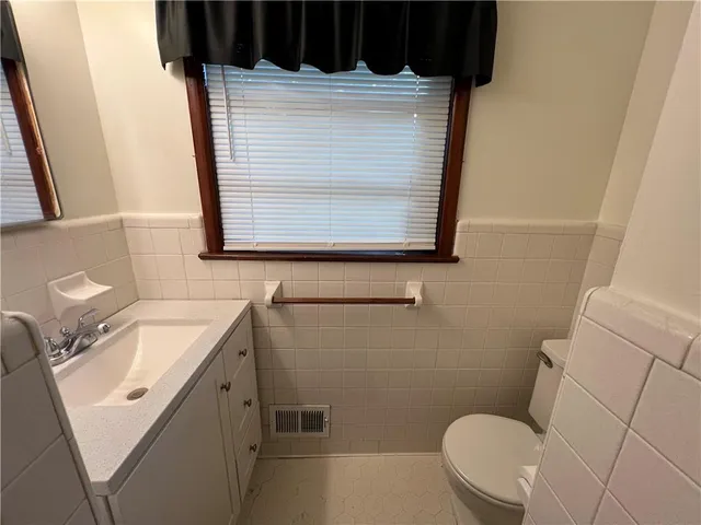 a bathroom with a sink toilet and mirror