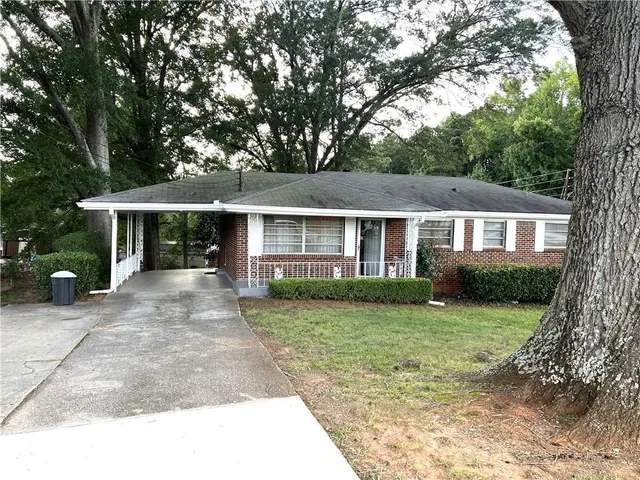 a front view of a house with a yard and porch