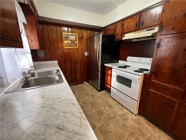 a view of a kitchen with a sink and dishwasher