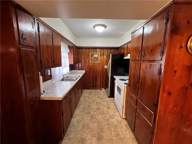 a kitchen with a sink refrigerator and microwave