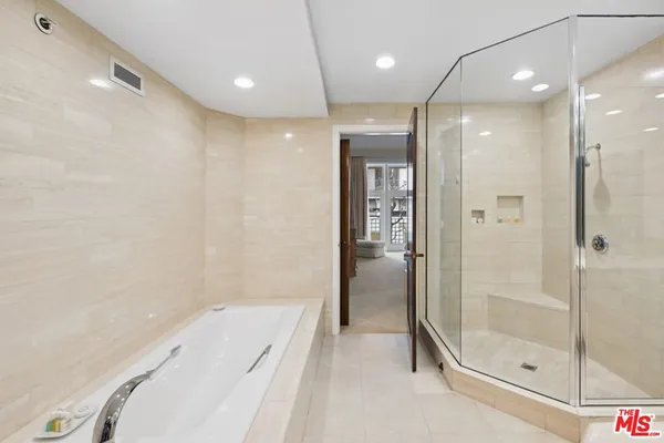 a bathroom with a tub and shower