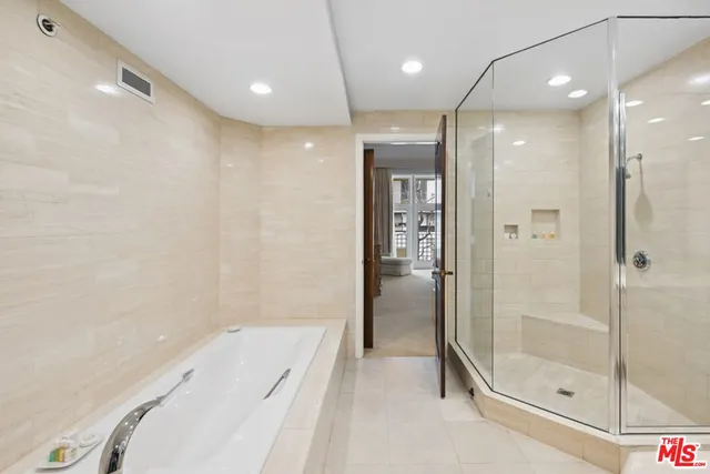 a bathroom with a tub and shower
