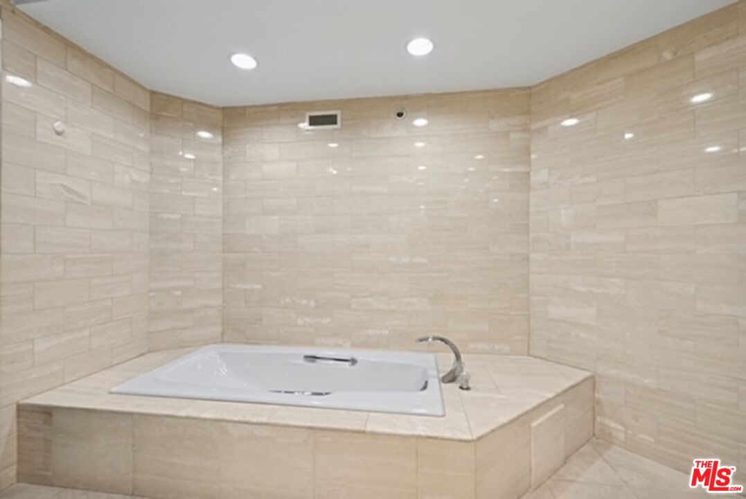 10351 Wilshire Boulevard, Unit PH1 Los Angeles, CA 90024 - Photo 13 of 23 a bathroom with a tub a sink and a shower