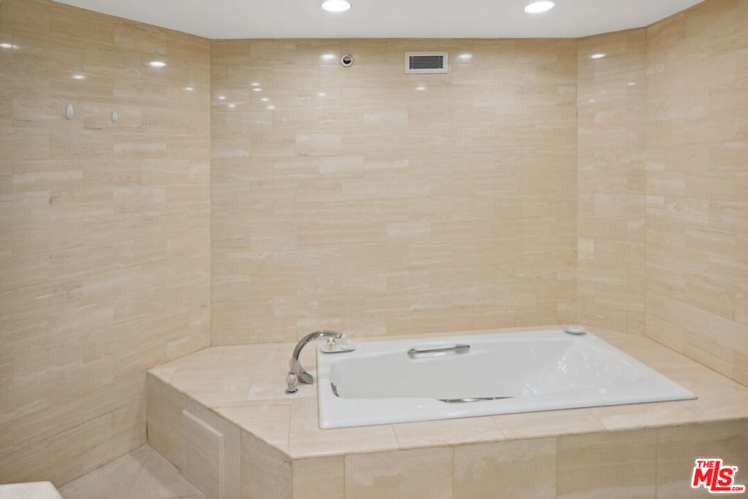 10351 Wilshire Boulevard, Unit PH1 Los Angeles, CA 90024 - Photo 14 of 23 a bathroom with a tub a shower and a sink