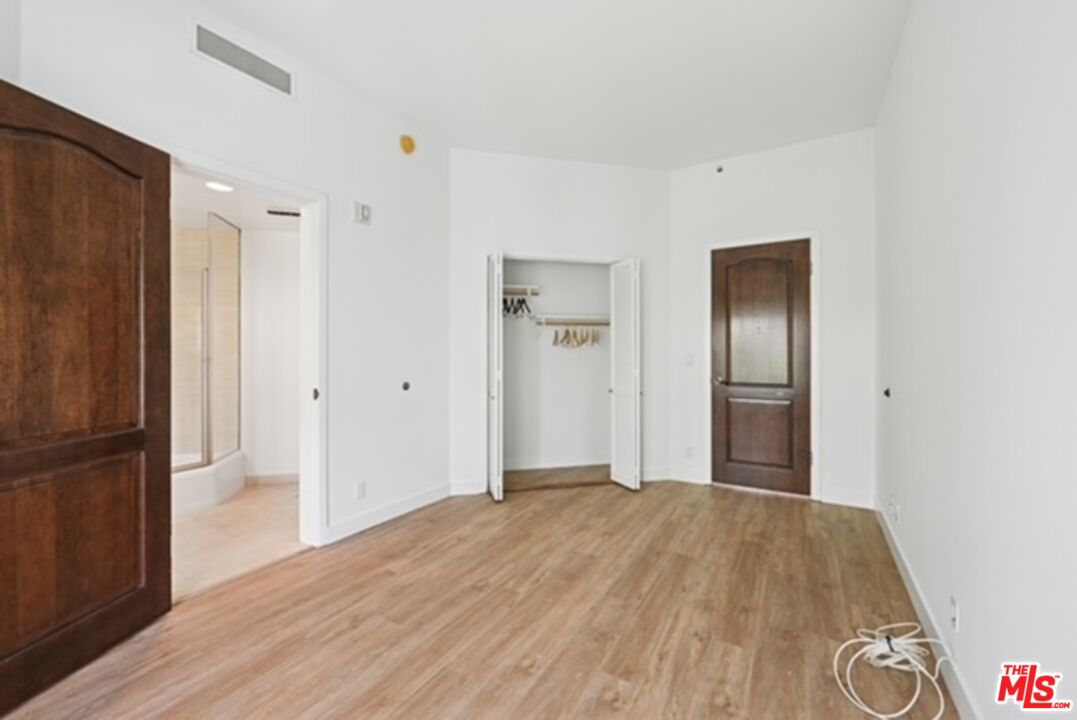 10351 Wilshire Boulevard, Unit PH1 Los Angeles, CA 90024 - Photo 17 of 23 a view of a big room with wooden floor and a cabinet