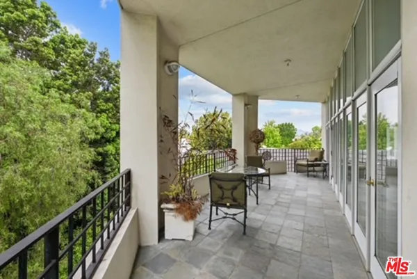 a view of a porch with chairs and backyard