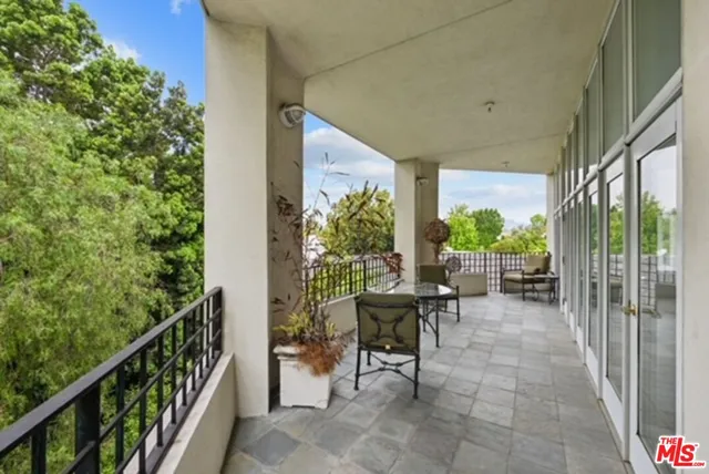 a view of a porch with chairs and backyard
