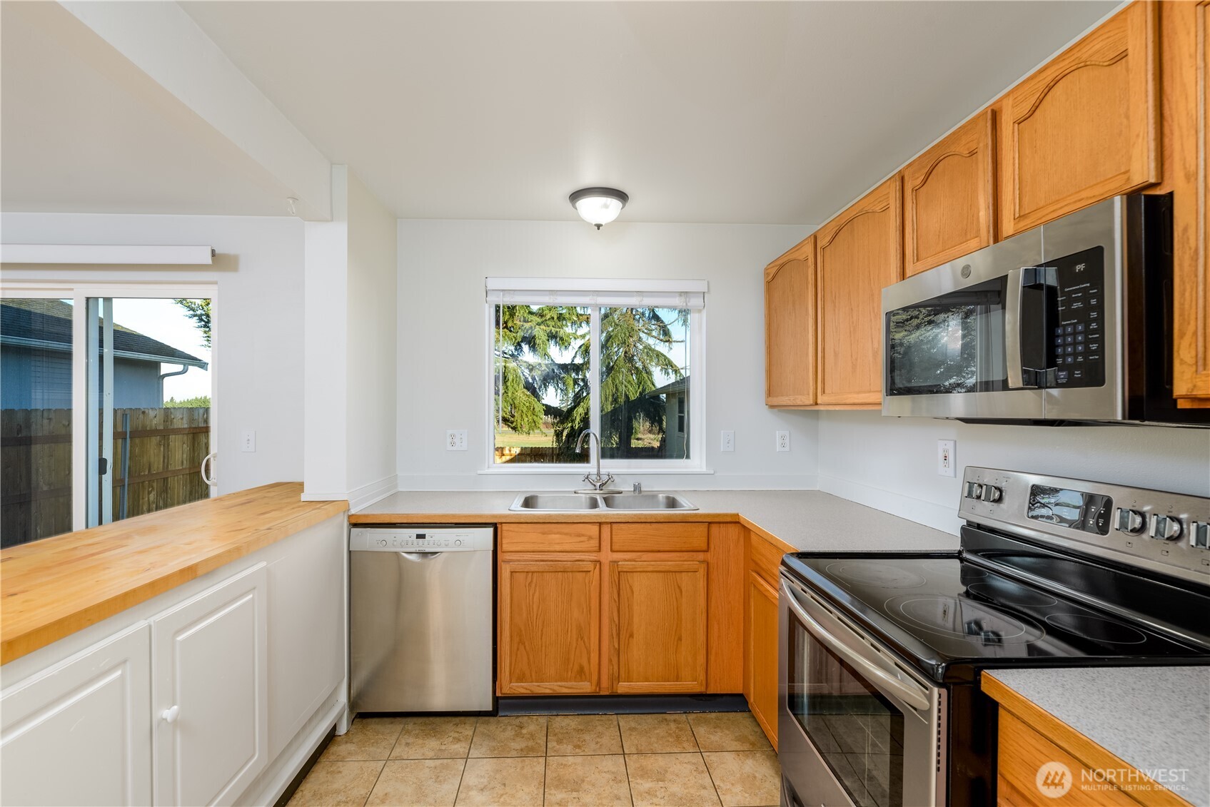 131 Alpine Loop Sequim, WA 98382 - Photo 13 of 40 a kitchen with a sink stove top oven and microwave