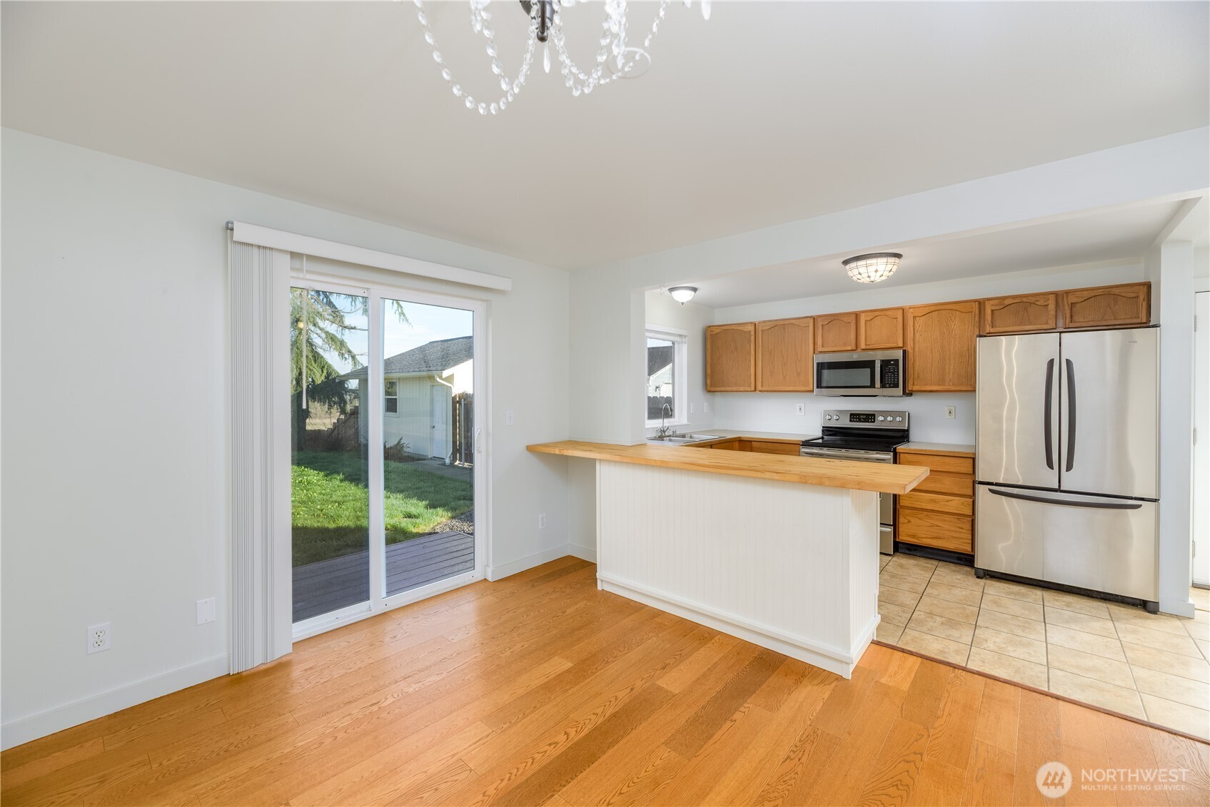 131 Alpine Loop Sequim, WA 98382 - Photo 15 of 40 a kitchen with stainless steel appliances a refrigerator sink and microwave
