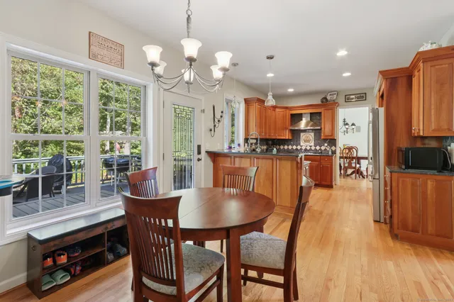 a dining room filled chandelier and wooden floor