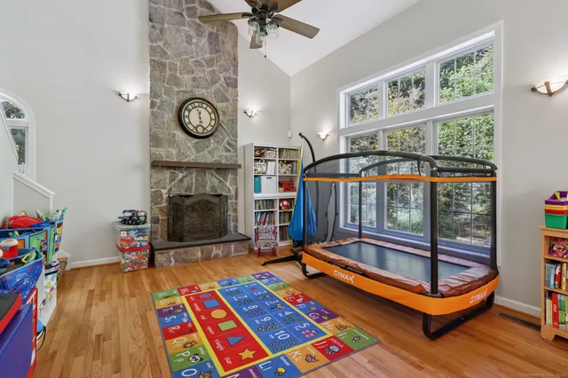 a living room with furniture a rug and a floor to ceiling window