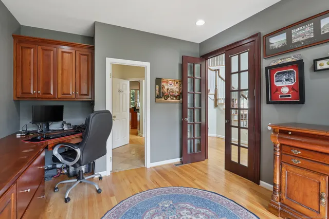 a view of a workspace with furniture and a window