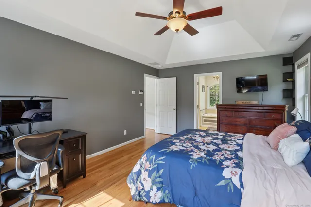 a bedroom with a bed and a flat screen tv