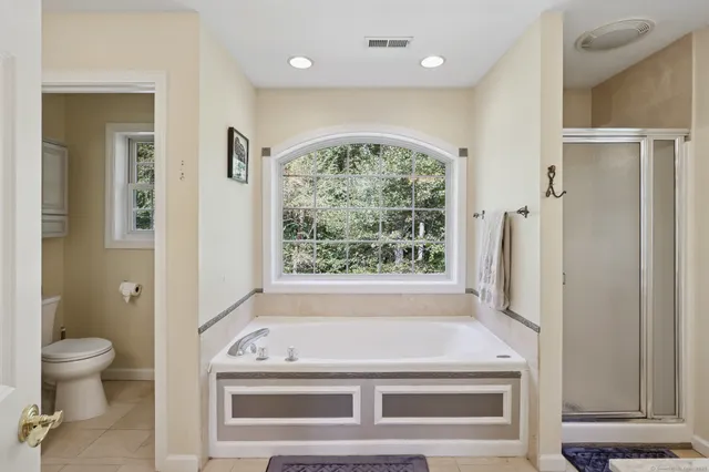 a bathroom with a tub sink and toilet