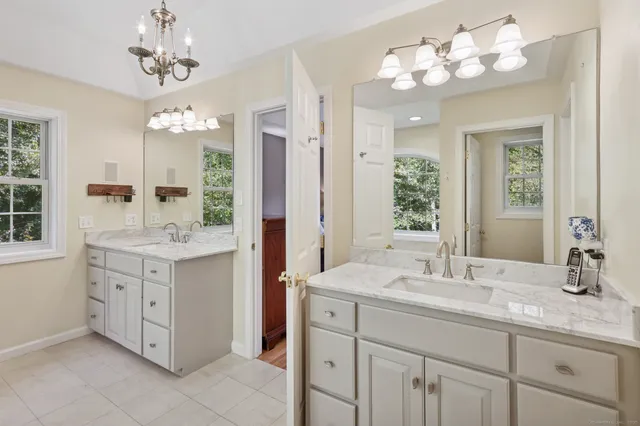 a bathroom with a double vanity sink and a mirror