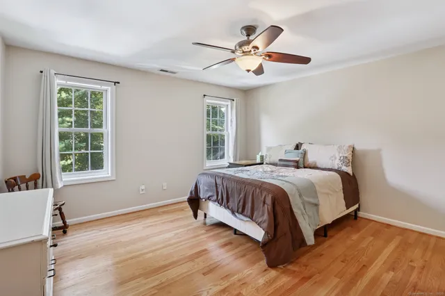 a spacious bedroom with a bed and a window