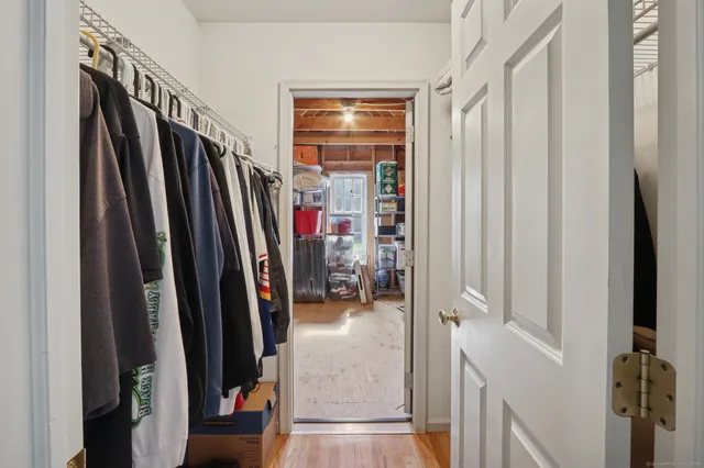 a view of walk in closet with clothes and shoes