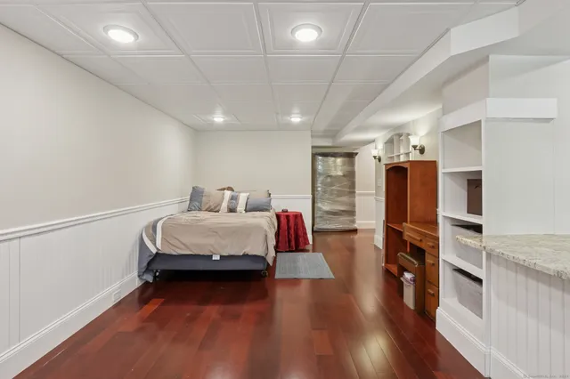 a bedroom with furniture and a wooden floor