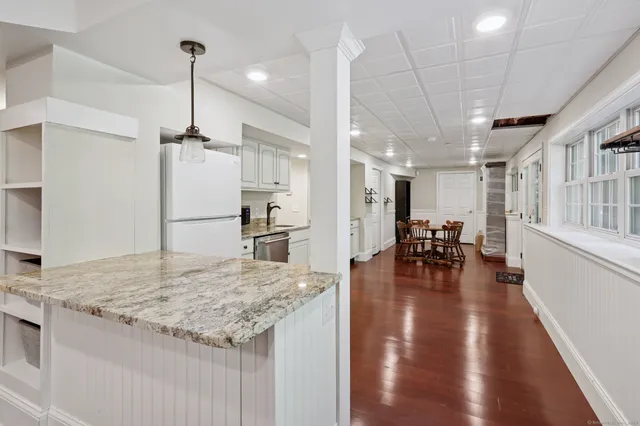 a kitchen with sink and refrigerator