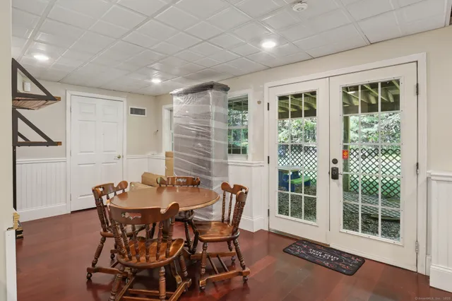 a dining room with furniture and large windows