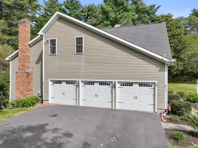 a view of a house with a yard and garage