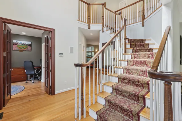 a view of entryway and hall with wooden floor