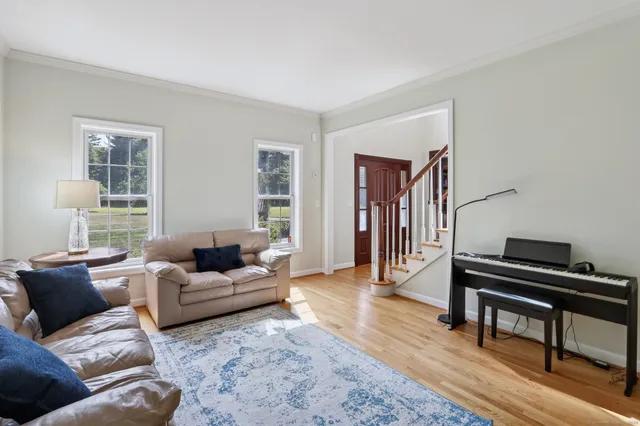 a living room with furniture and a piano