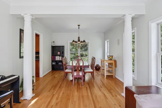 a view of a dining room with furniture window and wooden floor