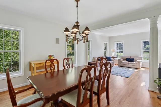 a view of a dining room with furniture window and wooden floor