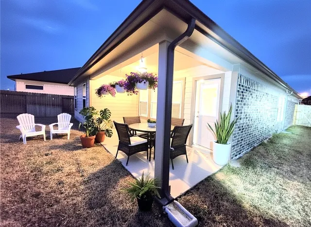 a view of a porch with furniture and floor to ceiling window