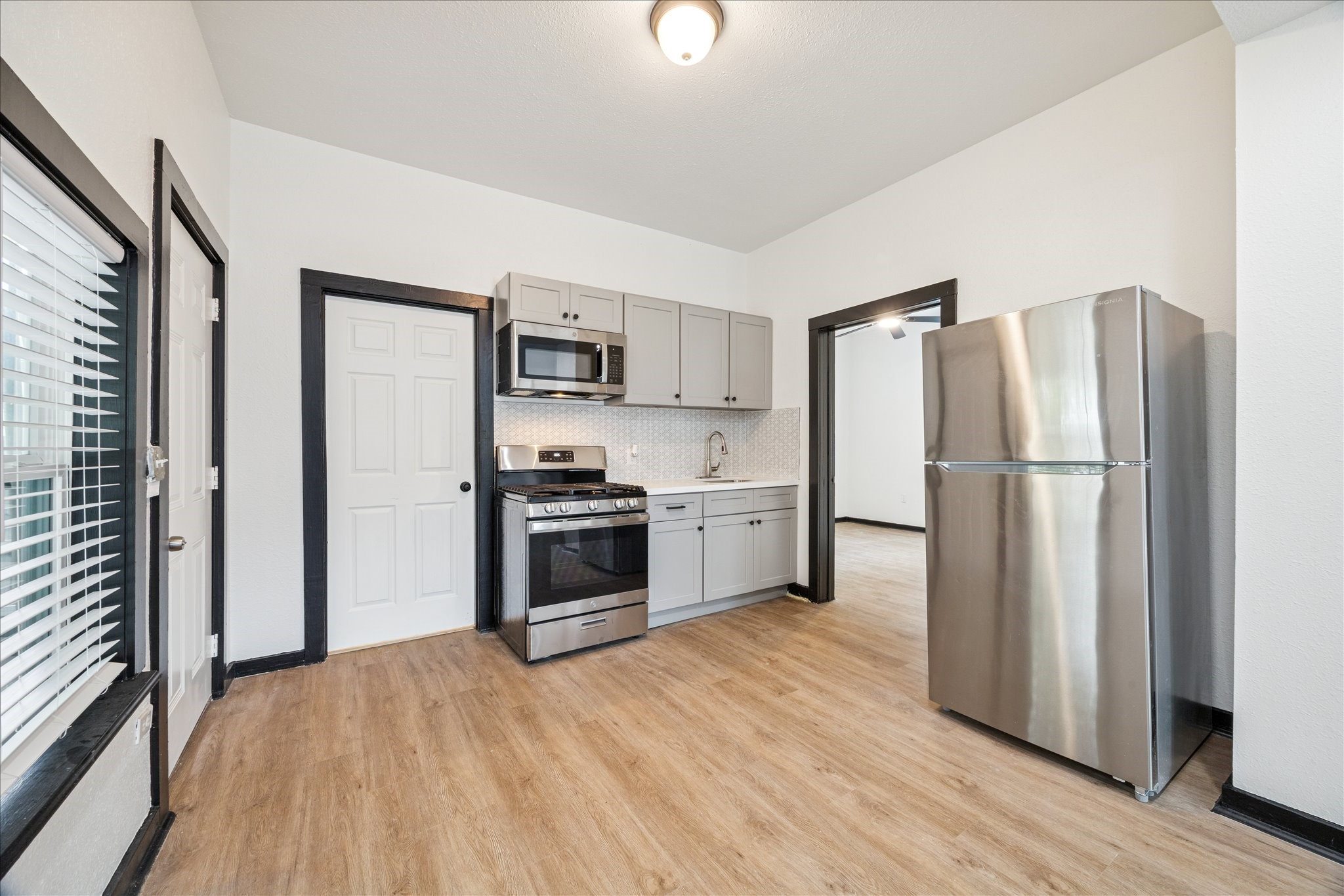 502 Gregg Street Houston, TX 77020 - Photo 1 of 11 a kitchen with a refrigerator a stove top oven and wooden floor