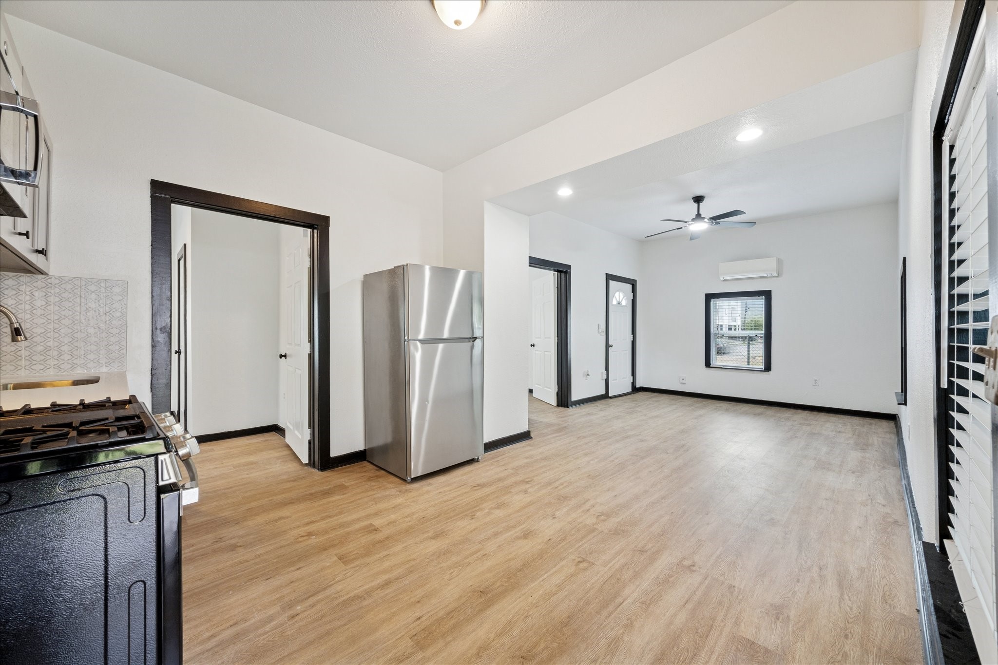 502 Gregg Street Houston, TX 77020 - Photo 4 of 11 a view of a kitchen with refrigerator and wooden floor