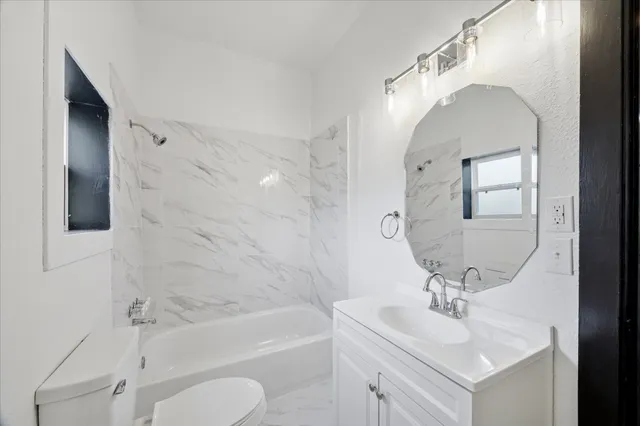 a bathroom with a sink toilet and bathtub