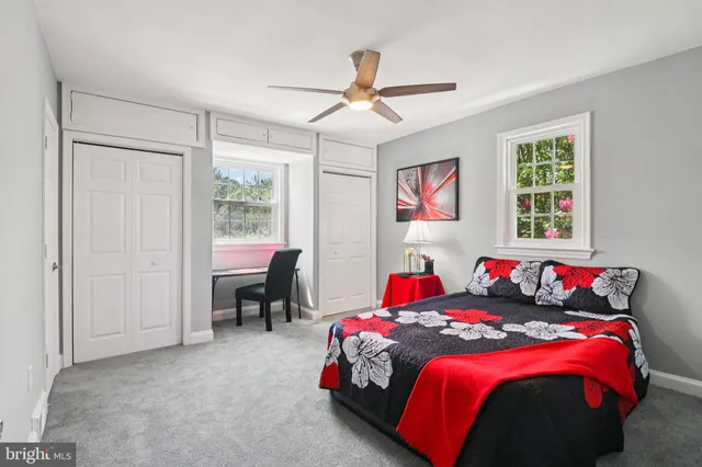 a bedroom with bed and windows