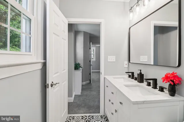 a bathroom with a sink vanity and a mirror