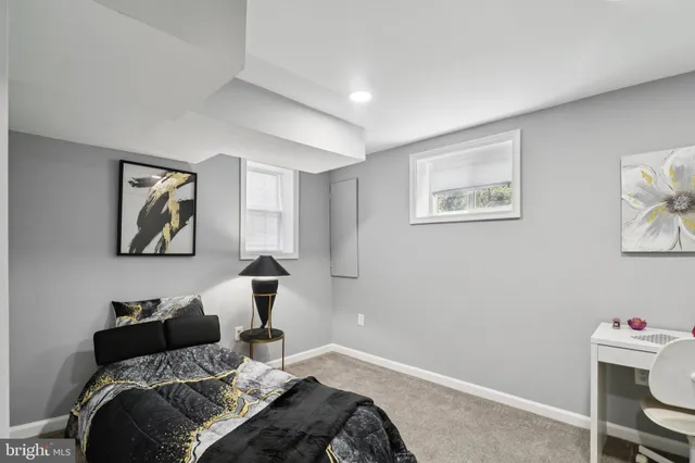 a bedroom with a bed and painting on the wall