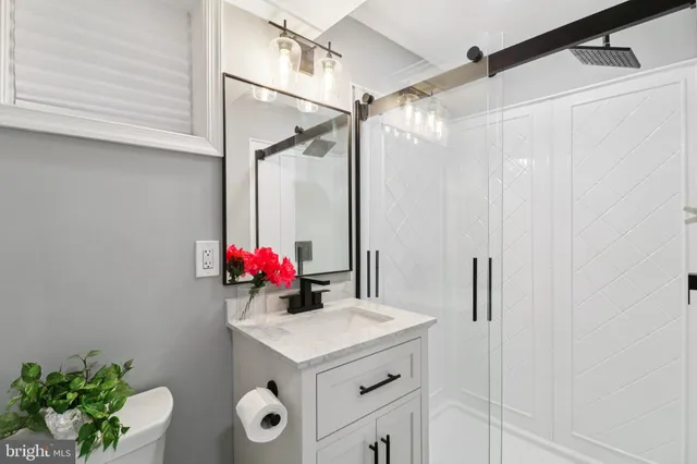 a bathroom with a sink vanity and a mirror