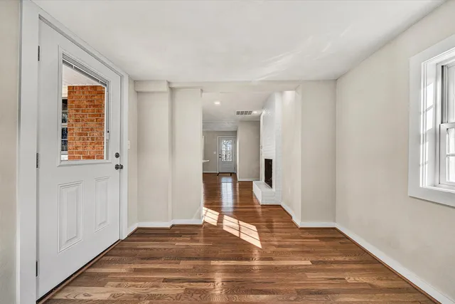 a view of a room with wooden floor and windows