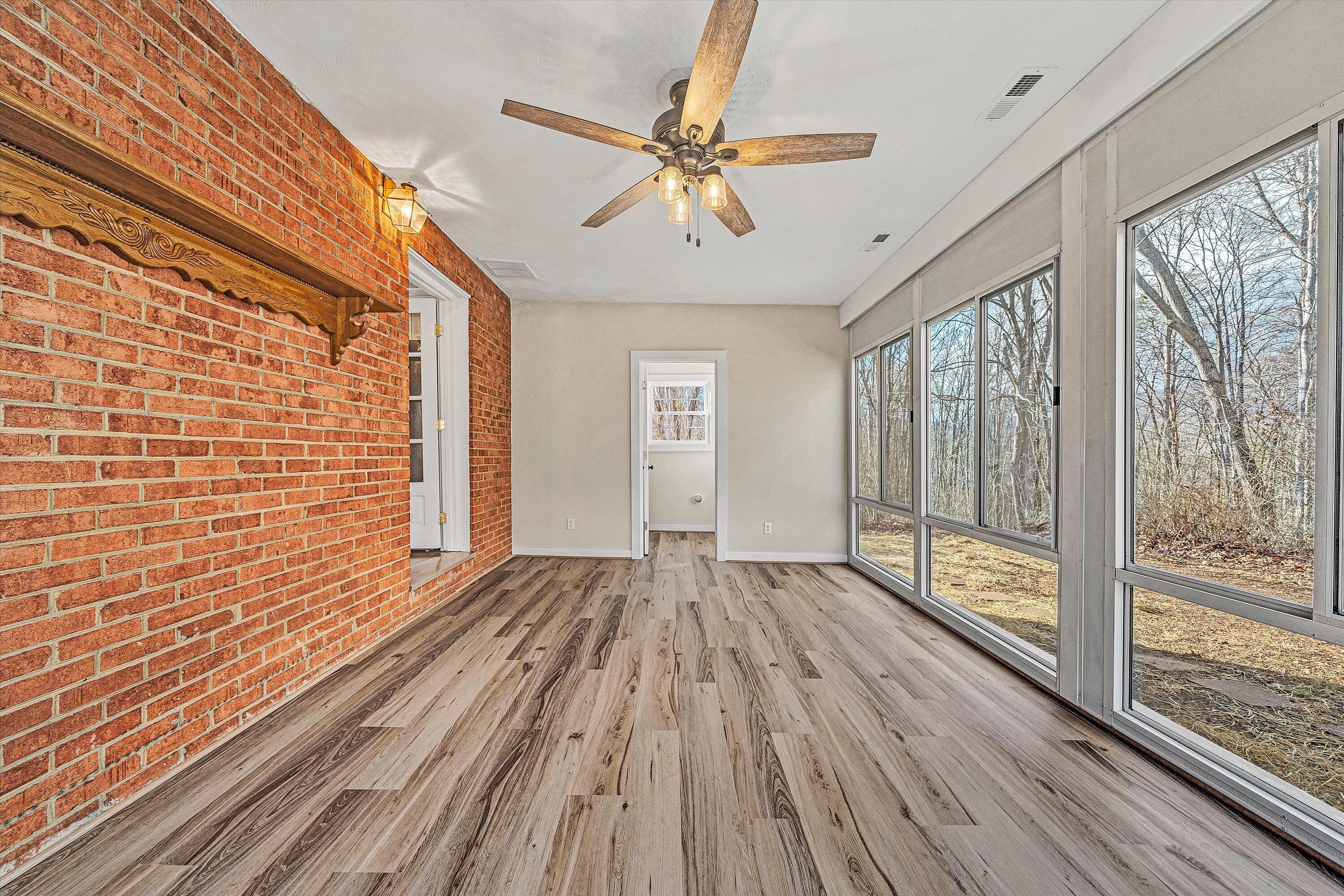 4883 Edwardsville Road Hardy, VA 24101 - Photo 23 of 32 a view of an empty room with wooden floor and a window
