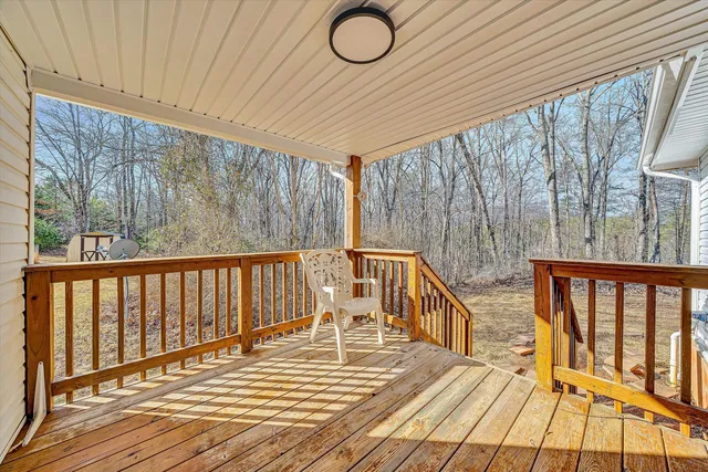 a view of balcony with wooden floor and fence
