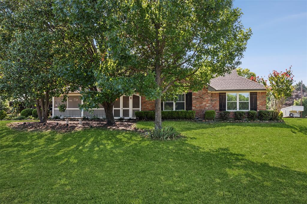 1980 Winningkoff Road Lucas, TX 75002 - Photo 2 of 35 Brick exterior with white-framed windows and dark shutters