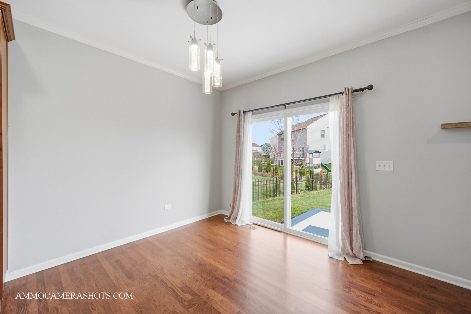4308 Fraser Circle Naperville, IL 60564 - Photo 13 of 43 a view of an empty room with wooden floor and a window